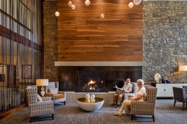 Tarkett Flooring in a warm lounge area with a fireplace and comfortable seating.