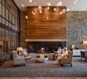 Tarkett Flooring in a warm lounge area with a fireplace and comfortable seating.