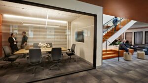 Conference rooms with expansive glass, one of the shared amenity spaces in San Mateo Medical Center’s Administration Building, create connection to the light of the open office area and encourages interaction among staff who had long worked in more traditional, enclosed environments.
