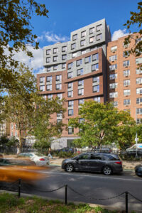 The design team carefully considered each element of the program, which includes a mix of 74 studio, one-, two-, and three-bedroom apartments, along with administrative offices, community and support spaces, a rear garden, and an elevated outdoor recreation area.